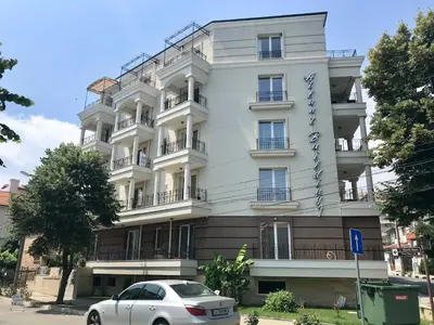a white car parked in front of a building at Apartment RAYA in Obzor