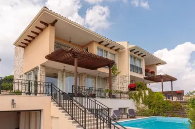 a house with a swimming pool in front of it at Coral Luxury Villas in Lozenets