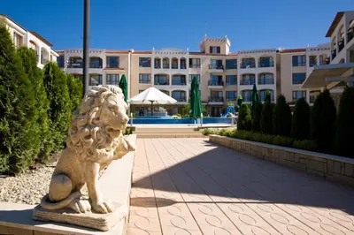 a statue of a lion in front of a building at Bay Apartments Sozopol in Sozopol