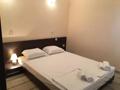 a bedroom with a bed with two towels on it at Bay Apartments Sozopol in Sozopol