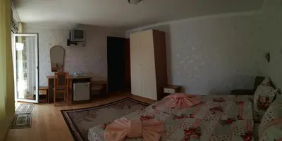 a small bedroom with a bed and a table at Anele,Kiten in Kiten