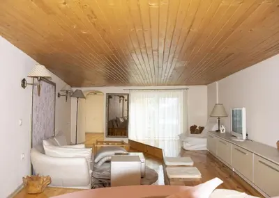 a living room with a wooden ceiling at Нестандартно Бутиково студио за двама Романтика in Varna City