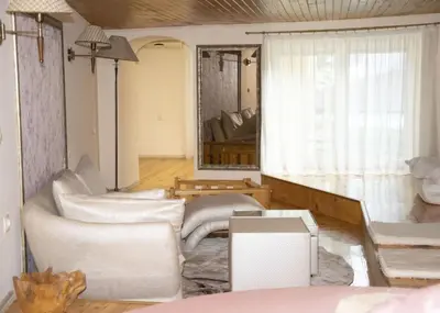 a living room with white furniture and a window at Нестандартно Бутиково студио за двама Романтика in Varna City