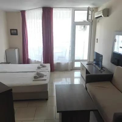 a hotel room with a bed and a couch at Hotel Radis in Kiten