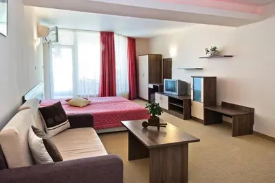 a hotel room with a bed and a couch at Hotel Radis in Kiten