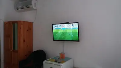 a flat screen tv hanging on a wall at Vila Riviera in Chernomorets