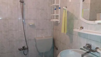 a bathroom with a shower and a toilet and a sink at Vila Riviera in Chernomorets