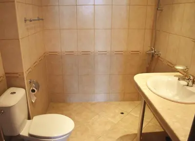 a bathroom with a toilet and a sink at Julia Vigo Panorama apartments in Nesebar