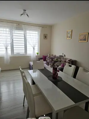 a living room with a dining room table and chairs at Апартаменти Кастро/Castro Apartments in Tsarevo
