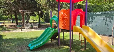 a playground with colorful slides in a park at Hotel Liani - All Inclusive in Sunny Beach