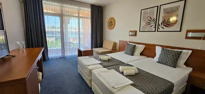 a hotel room with a bed and a desk at Hotel Liani - All Inclusive in Sunny Beach