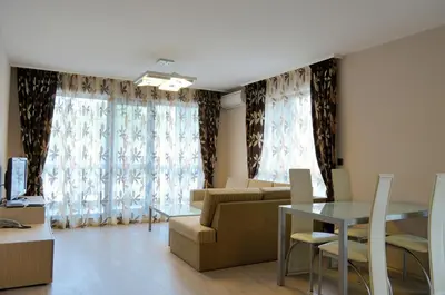a living room with a couch and a table at Iva Resort in Byala