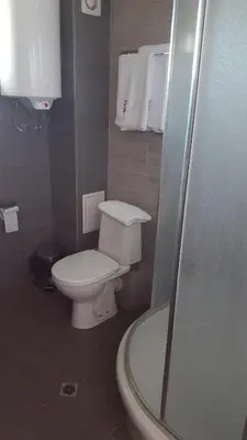 a small bathroom with a toilet and a shower at Iva Resort in Byala