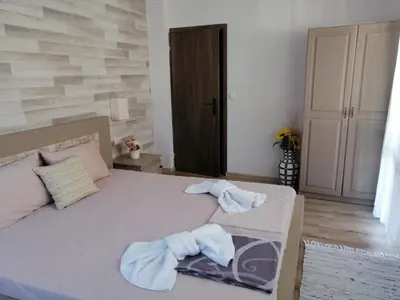 a bedroom with a bed with towels on it at Guest House Juja in Nesebar
