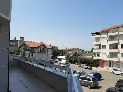 a balcony with a view of a parking lot at Апартаменти и стаи Мони Холидейс in Tsarevo