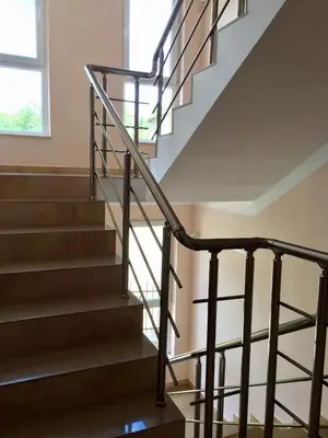 a staircase in a house with a glass railing at PANORAMA SUNRISE Byala Studio - rest and seaside recreation in Byala