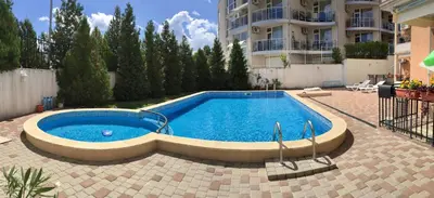 a large swimming pool in a courtyard with a building at PANORAMA SUNRISE Byala Studio - rest and seaside recreation in Byala