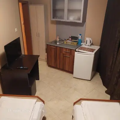 a small kitchen with a sink and a refrigerator at Hristovi Apartments & Studios in Pomorie