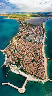 an aerial view of a city next to the water at Hristovi Apartments & Studios in Pomorie