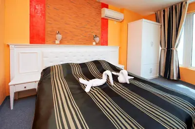 two stuffed animals laying on top of a bed at Family Hotel Paros in Pomorie