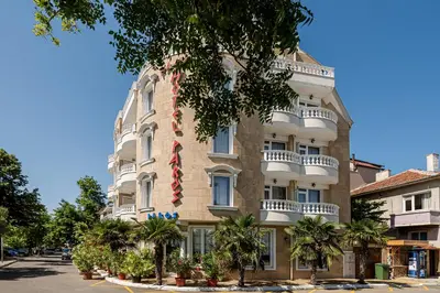 a building with a red and white tie on it at Family Hotel Paros in Pomorie