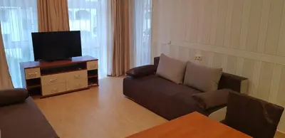 a living room with a couch and a flat screen tv at Aqua Dreams - new wifi in Sveti Vlas