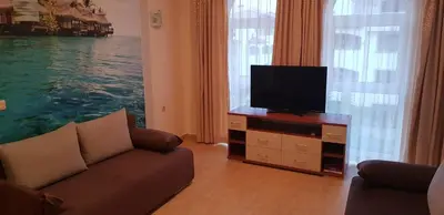 a living room with a couch and a flat screen tv at Aqua Dreams - new wifi in Sveti Vlas