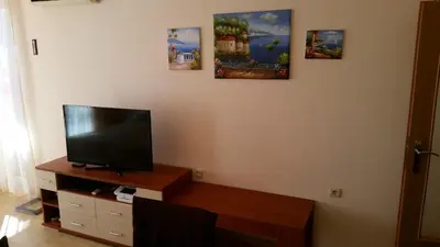 a living room with a flat screen tv on a table at Aqua Dreams - new wifi in Sveti Vlas