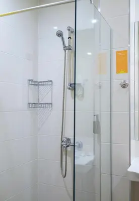 a bathroom with a shower with a glass door at Hotel Garden Nevis - All Inclusive in Sunny Beach