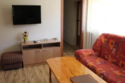 a living room with a couch and a table at Hotel Radik in Sozopol