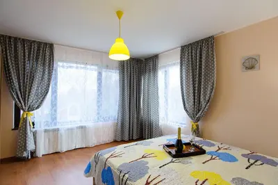 a bedroom with a bed and windows with curtains at Villa Varna View in Varna City