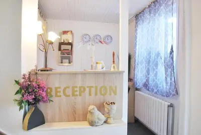 a room with a shelf with a vase of flowers at Family Hotel Apolonia in Sozopol