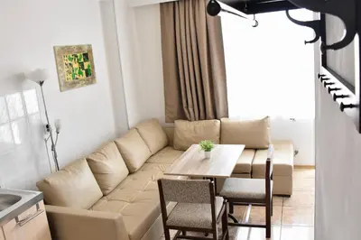 a living room with a couch and a table at Family Hotel Apolonia in Sozopol