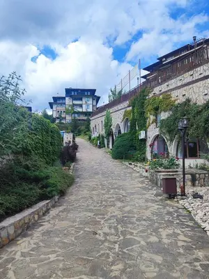 a cobblestone street in front of a building at Jacky's Apartament - Апартамент в Свети Влас in Sveti Vlas