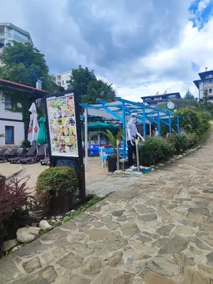 a man standing in front of a blue tent at Jacky's Apartament - Апартамент в Свети Влас in Sveti Vlas