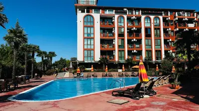 a hotel with a swimming pool in front of a building at Chateau del Marina Apart Complex in Nesebar