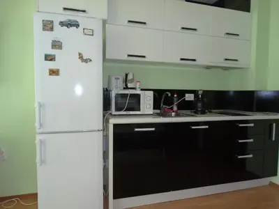 a kitchen with a white refrigerator and a microwave at Chateau del Marina Apart Complex in Nesebar