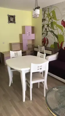 a white table and chairs in a living room at Chateau del Marina Apart Complex in Nesebar