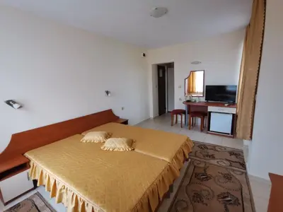 a bedroom with a bed and a living room at Guest House Georgieva Ravda in Ravda