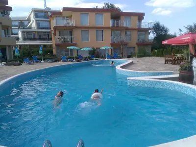 two people in a swimming pool in a hotel at Mappy Holidays Aparthotel in Sozopol