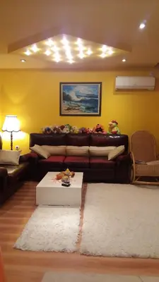 a living room with a couch and a table at Family Hotel Denica in Obzor