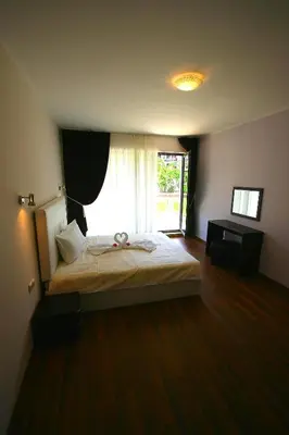 a bedroom with a bed and a large window at Sozopoli Style Club in Sozopol