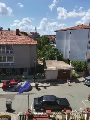 a car parked in a parking lot next to a building at Apart Hotel Hetodon in Sozopol