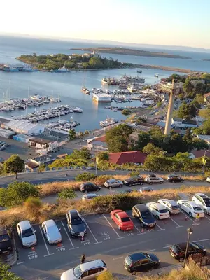 a parking lot with cars parked in a harbor at Guest House Hetodon in Sozopol