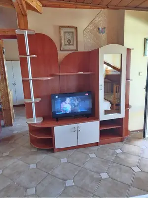 a living room with a tv and a mirror at Guest House Hetodon in Sozopol