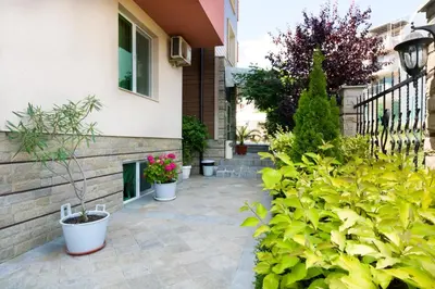 a courtyard of a house with potted plants at Siena House in Sozopol