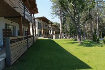 a house with a green lawn in front of it at Вилно селище 