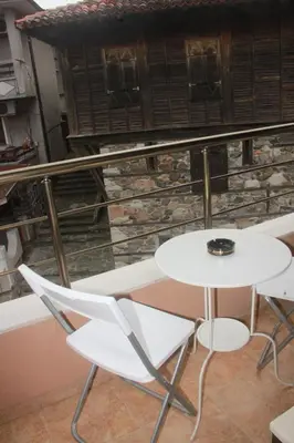 a white table and two chairs on a balcony at Family Hotel Emilia in Sozopol