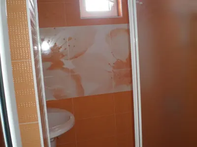a bathroom with a shower with a toilet and a sink at Panoramic Penthouse Sozopol in Sozopol