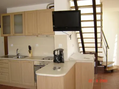 a kitchen with a tv on top of a counter at Panoramic Penthouse Sozopol in Sozopol